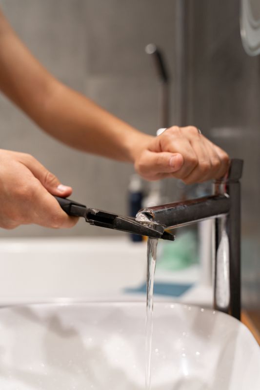 Handyman Repairing a Faucet